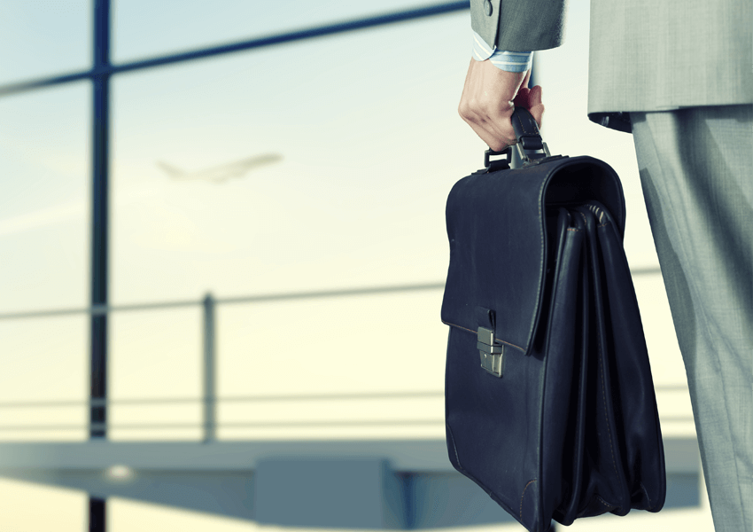 Man holding at airport, holding a bag