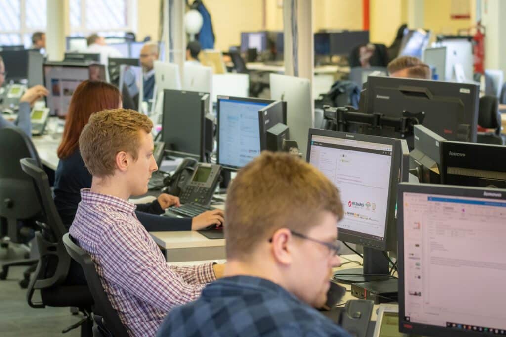 Employees at desks working at Williams Commerce Officer